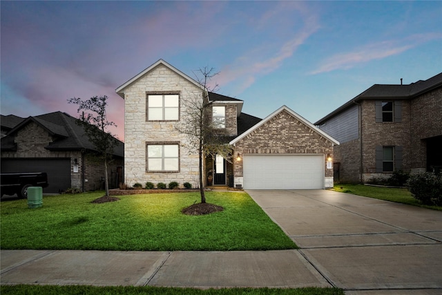 front of property featuring a garage and a lawn