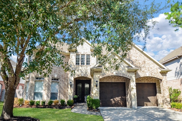 view of front of property featuring a garage and french doors