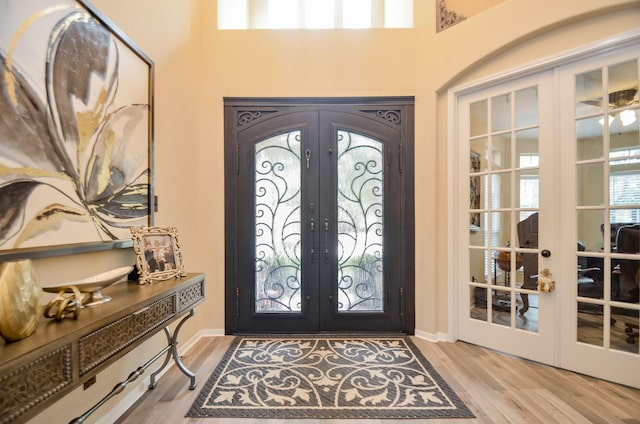 foyer featuring light hardwood / wood-style floors and french doors