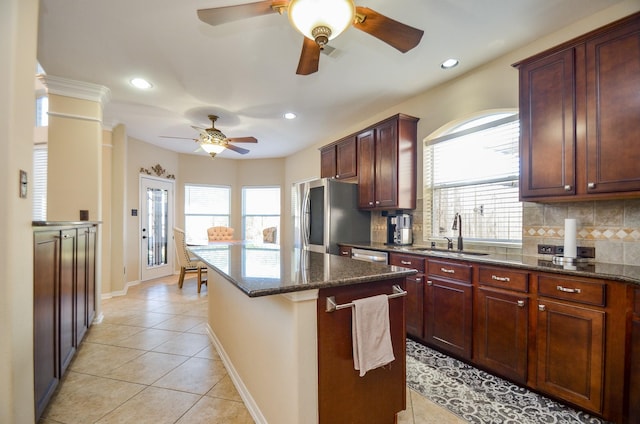 kitchen featuring decorative backsplash, appliances with stainless steel finishes, plenty of natural light, and sink