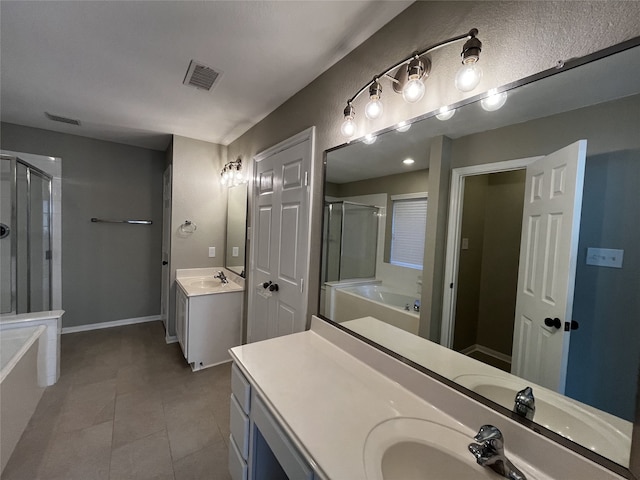 bathroom with tile patterned floors, vanity, and shower with separate bathtub