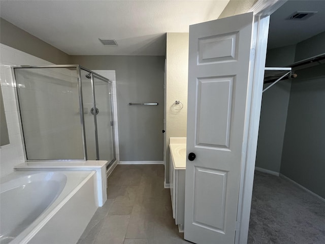 bathroom featuring tile patterned floors, vanity, and plus walk in shower