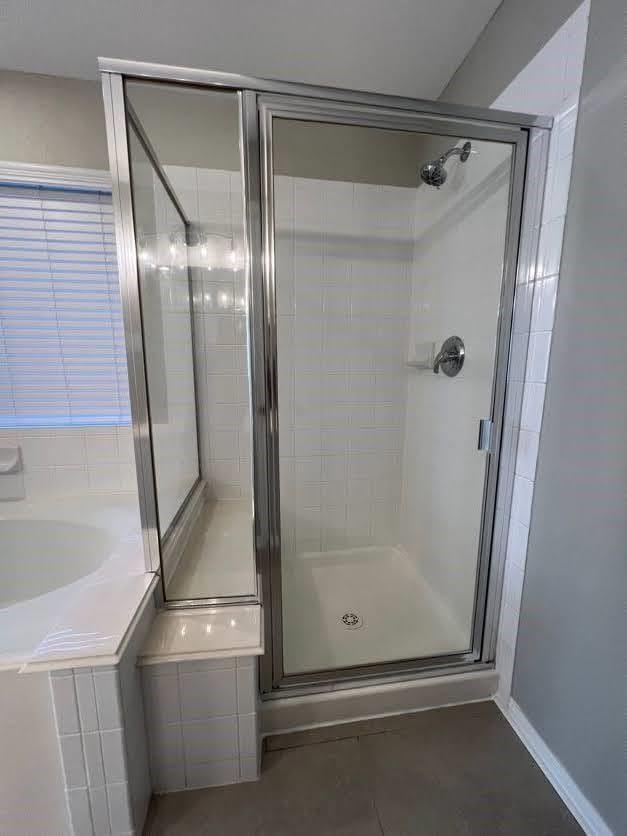 bathroom featuring plus walk in shower