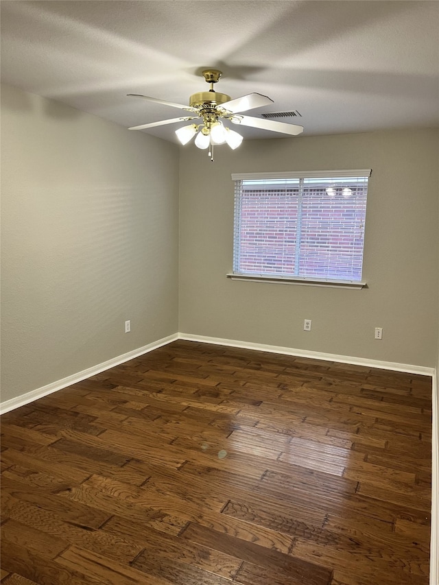 empty room featuring dark hardwood / wood-style floors and ceiling fan