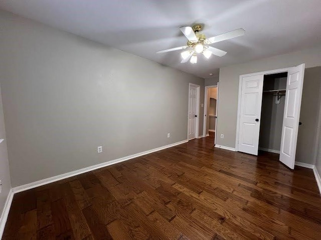 unfurnished bedroom with a closet, dark hardwood / wood-style floors, and ceiling fan