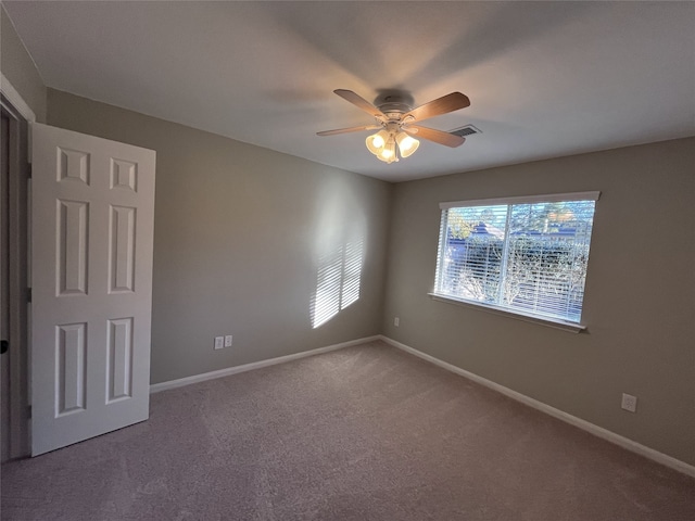 unfurnished room featuring ceiling fan and carpet floors