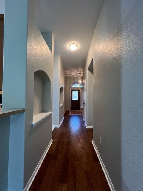 corridor featuring dark hardwood / wood-style flooring