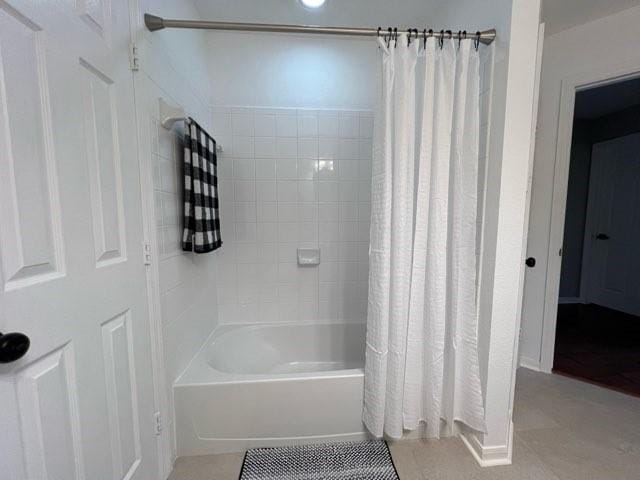 bathroom featuring tile patterned flooring and shower / bathtub combination with curtain