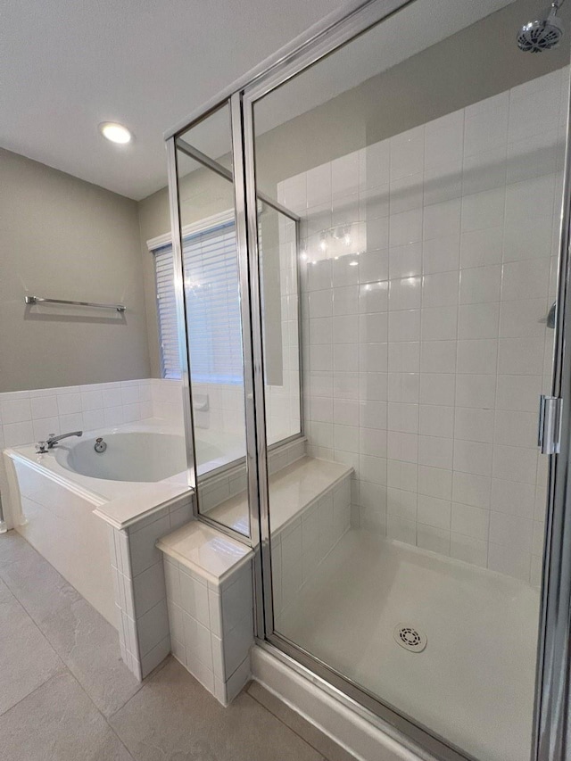 bathroom featuring tile patterned flooring and shower with separate bathtub