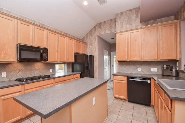 kitchen featuring light brown cabinets, a center island, lofted ceiling, and black appliances