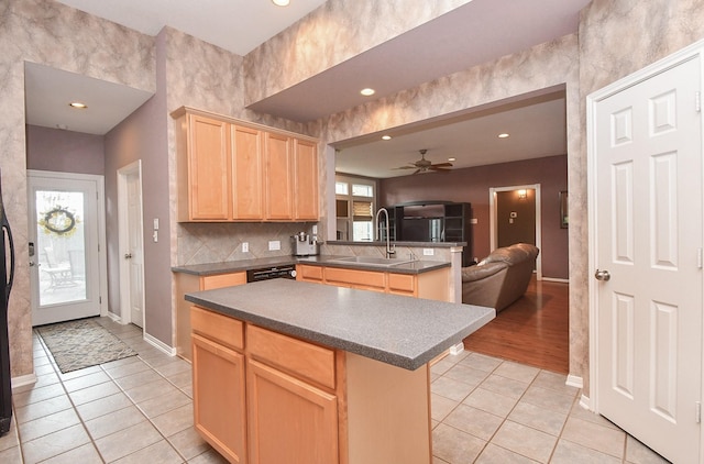 kitchen featuring sink, ceiling fan, light tile patterned floors, light brown cabinetry, and a kitchen island