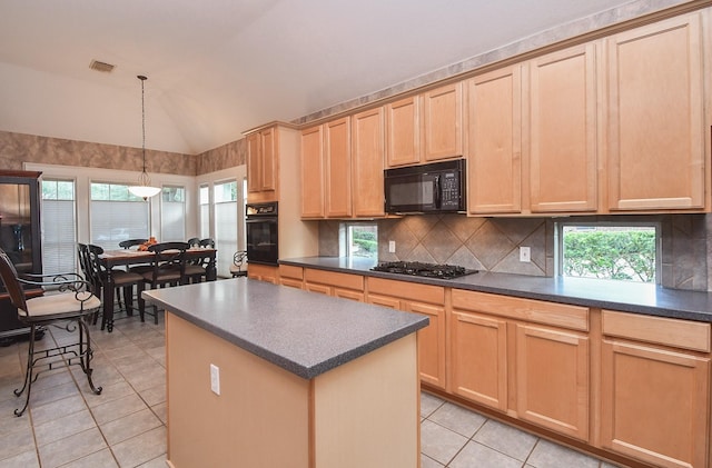 kitchen featuring light tile patterned floors, lofted ceiling, light brown cabinetry, a kitchen island, and black appliances