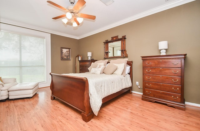 bedroom with light hardwood / wood-style floors, ceiling fan, and ornamental molding