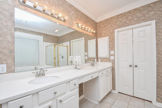 bathroom featuring tile patterned flooring, vanity, a shower with shower door, and ornamental molding