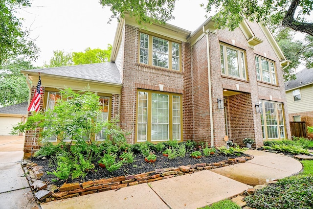 2446 Plantation Bend Dr, Sugar Land, TX 77478 - traditional-style house with brick siding and a shingled roof