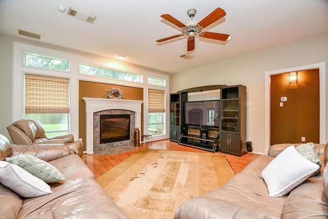 2446 Plantation Bend Dr, Sugar Land, TX 77478 - living area featuring wood finished floors, ceiling fan, and a fireplace