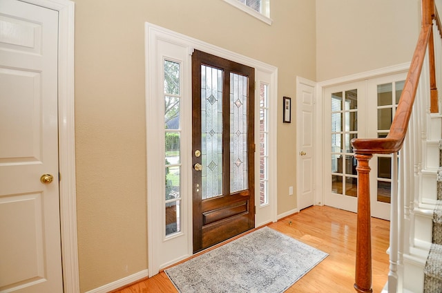 foyer entrance with french doors and hardwood / wood-style flooring