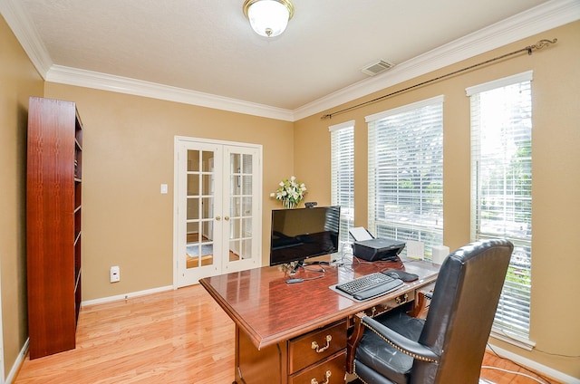 office space with french doors, ornamental molding, and light hardwood / wood-style flooring