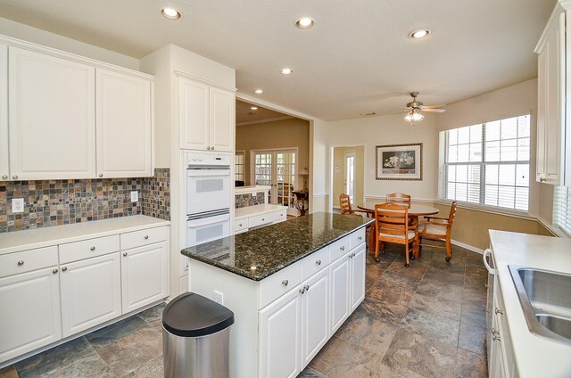 kitchen featuring plenty of natural light, white cabinetry, and tasteful backsplash