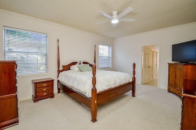 bedroom featuring ceiling fan, ornamental molding, and light carpet