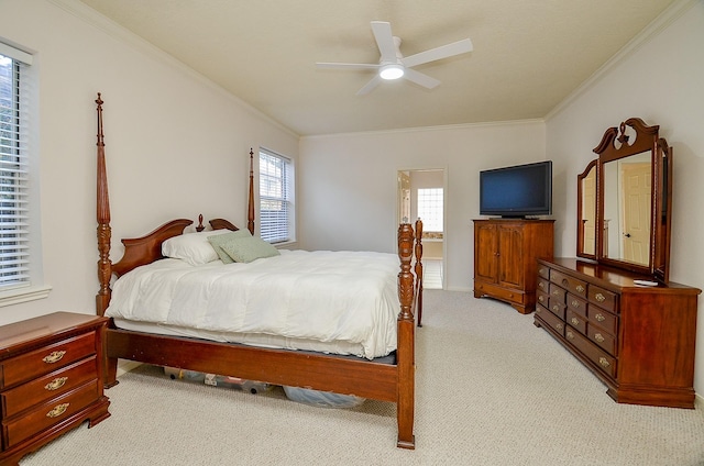 carpeted bedroom with ceiling fan and ornamental molding