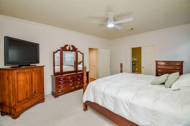 bedroom with light carpet, a textured ceiling, ceiling fan, and ornamental molding