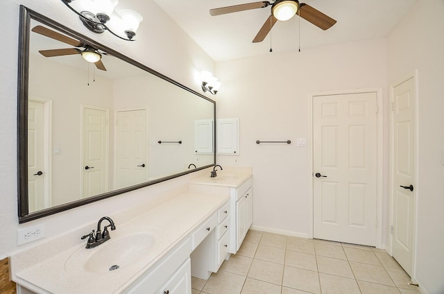 bathroom with tile patterned flooring, vanity, and ceiling fan