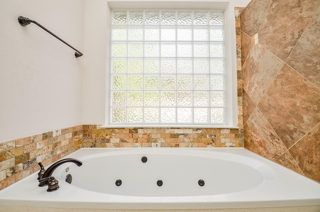 bathroom with a tub to relax in and a wealth of natural light