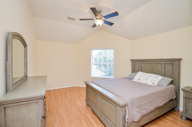 bedroom featuring ceiling fan, light hardwood / wood-style floors, and vaulted ceiling