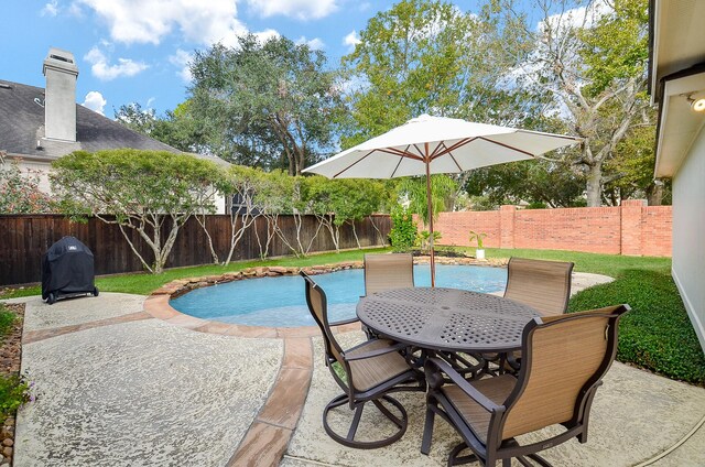 view of swimming pool featuring pool water feature and a patio area