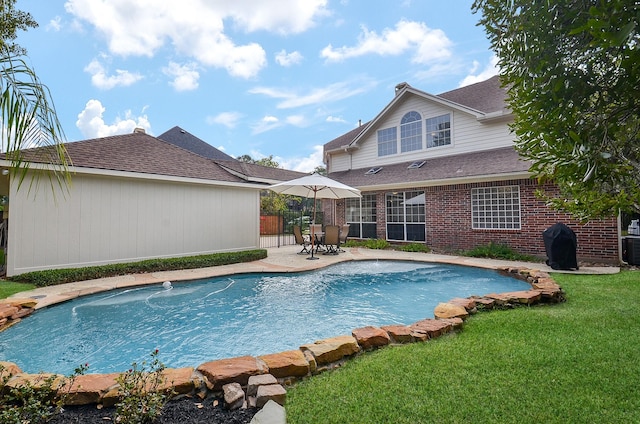 view of swimming pool featuring central AC unit, area for grilling, a patio area, and a yard