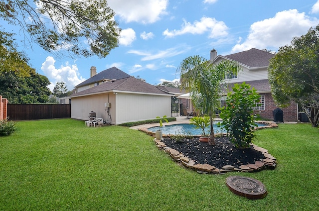 view of yard with a fenced in pool