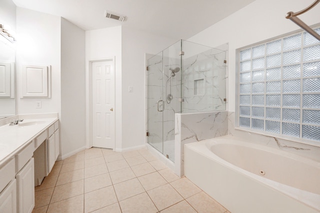 bathroom with tile patterned flooring, vanity, and independent shower and bath