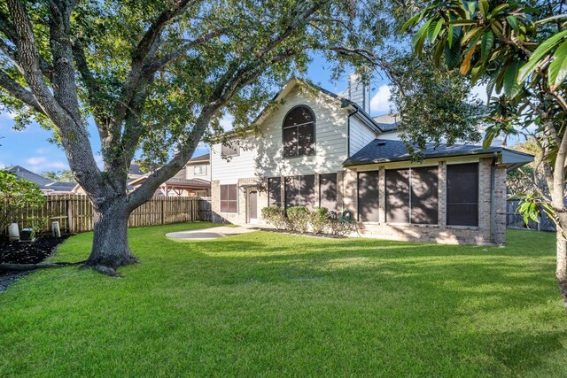 back of property featuring a lawn