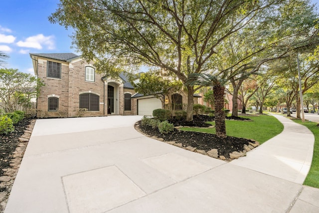 view of front of home featuring a garage and a front lawn