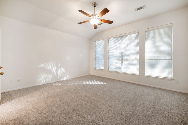 carpeted spare room featuring ceiling fan and lofted ceiling