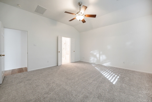 carpeted spare room with ceiling fan and lofted ceiling