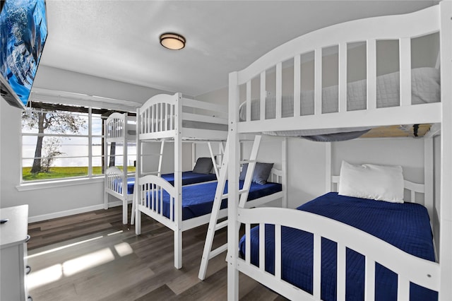 bedroom with dark wood-type flooring