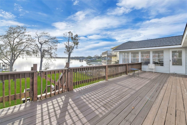 wooden deck featuring a yard and a water view