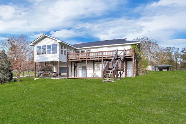 rear view of property with a lawn, a patio area, a sunroom, and a deck