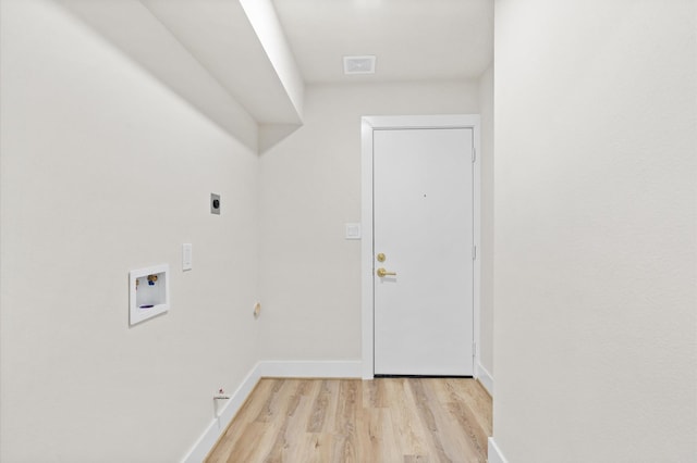 washroom with electric dryer hookup, hookup for a gas dryer, hookup for a washing machine, and light hardwood / wood-style floors