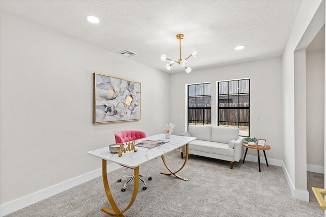 office space with carpet floors, a textured ceiling, and an inviting chandelier