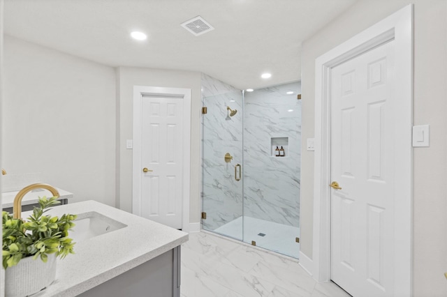 bathroom featuring vanity and a shower with door