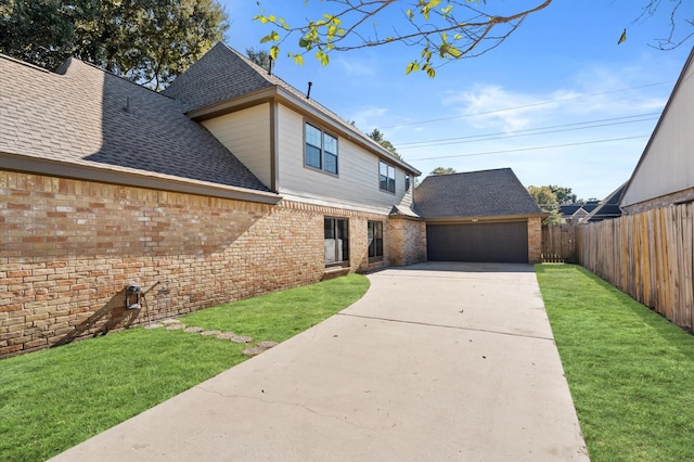 view of front of property with a front yard and a garage