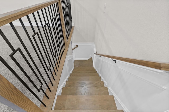 stairway with hardwood / wood-style floors