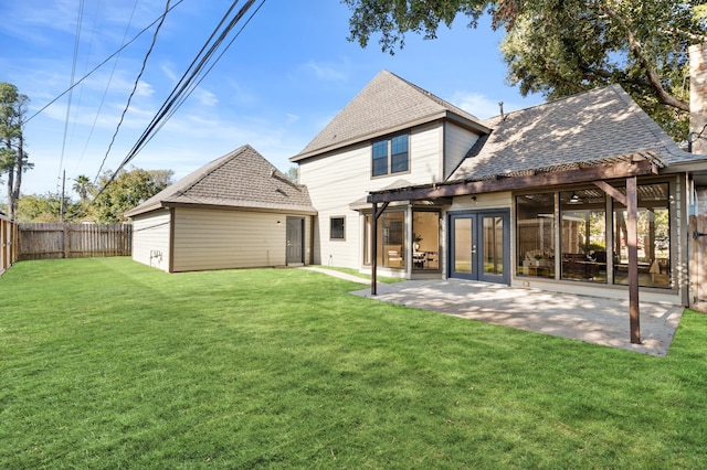 back of property featuring a pergola, a yard, and french doors