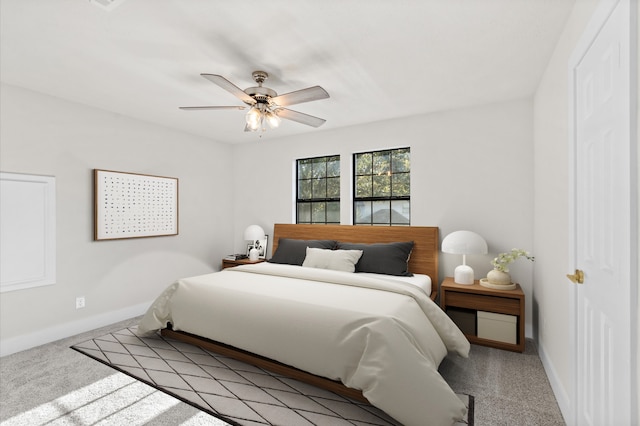 bedroom featuring ceiling fan and light carpet