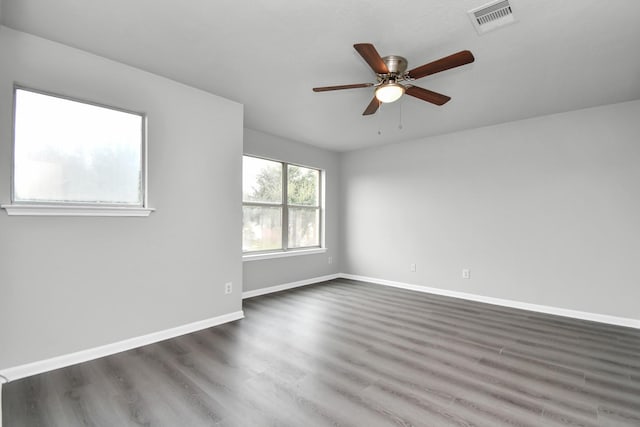 spare room featuring dark hardwood / wood-style floors and ceiling fan