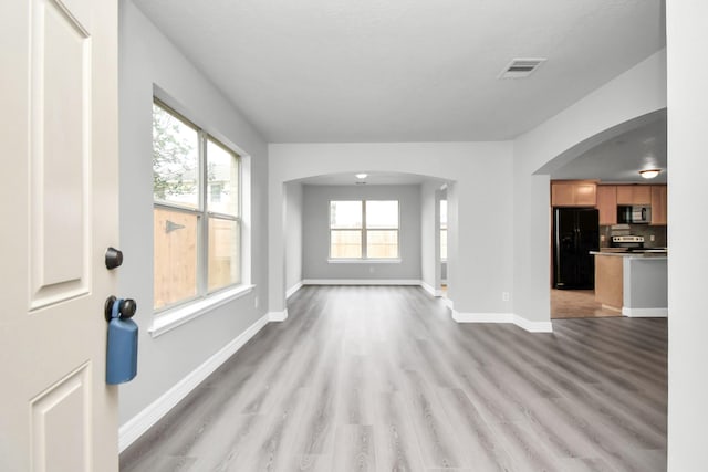 unfurnished living room featuring light wood-type flooring