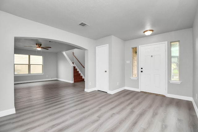 entrance foyer with ceiling fan and light hardwood / wood-style flooring